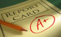 A reporting card signed "A plus"