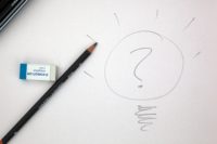 a pencil and an eraser on a white paper