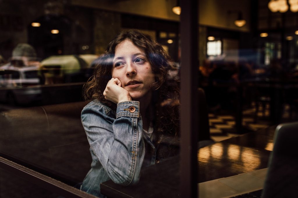 woman sitting in a cafe thinking