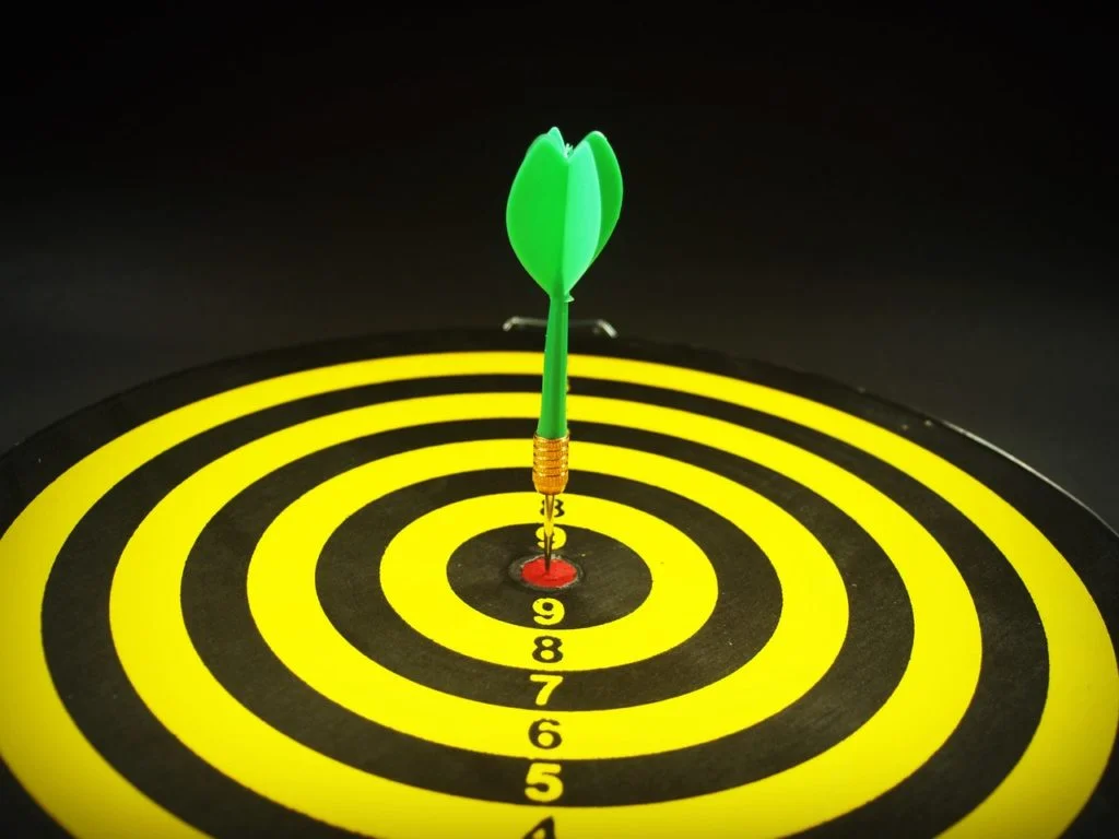 a dartboard with an arrow in the center