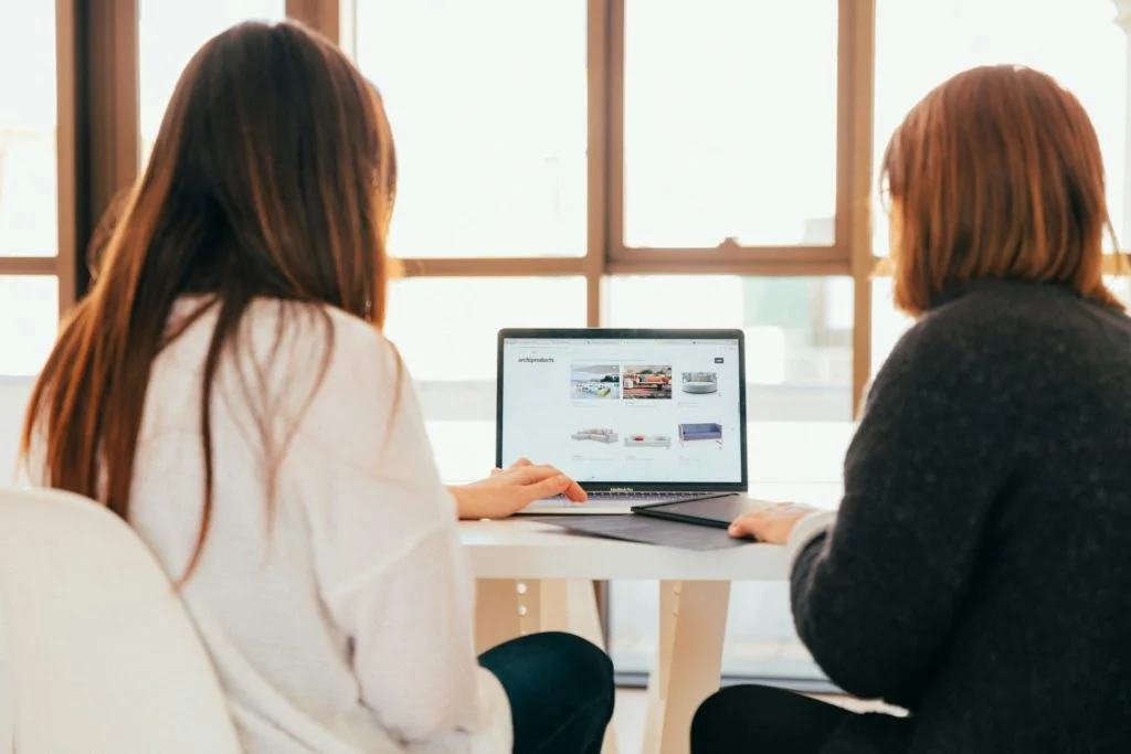 two girls with a laptop